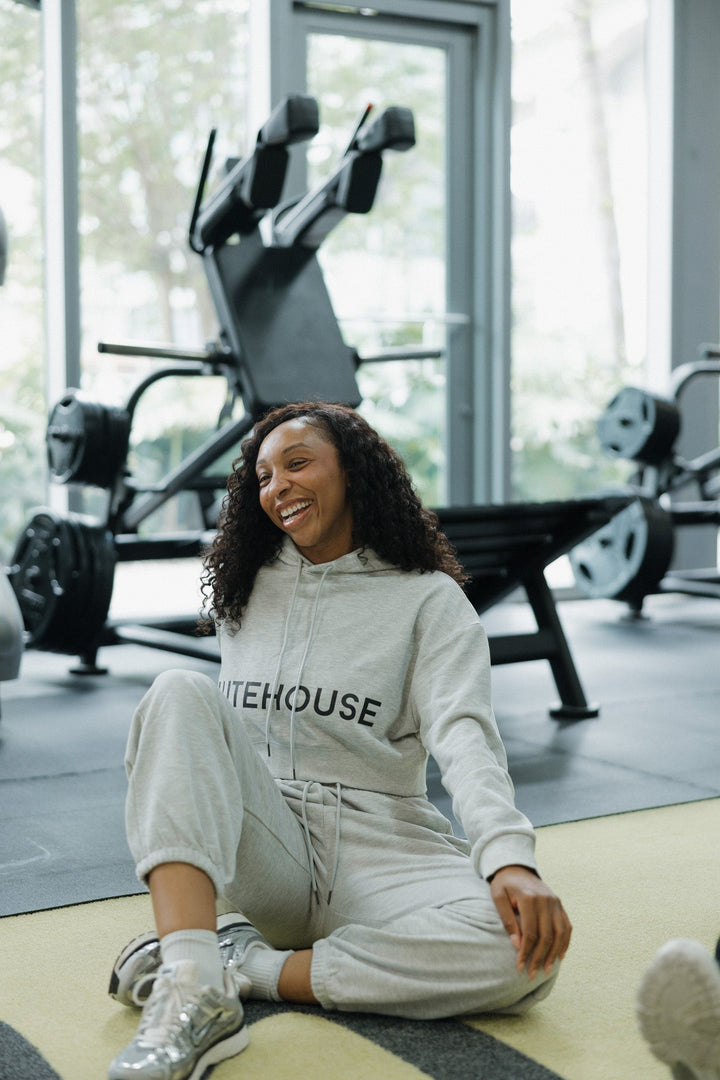 Model wearing the GluteHouse Crop Hoodie and Jogger Sweatpants Set in flower gray